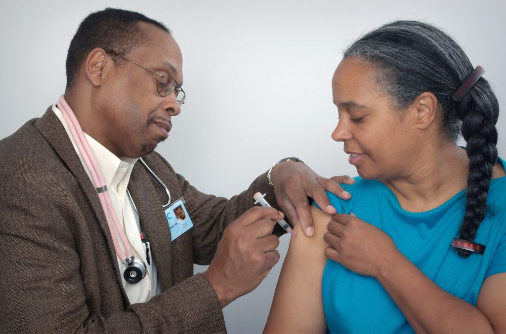 Doctor vaccinating a patient