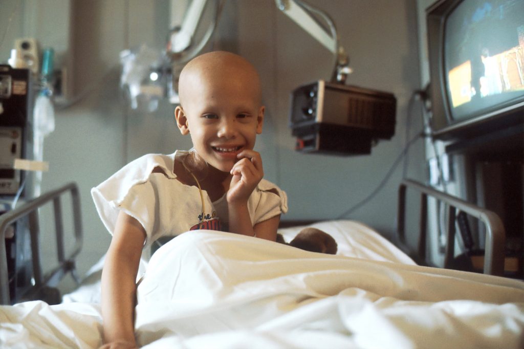 Child with cancer in hospital bed