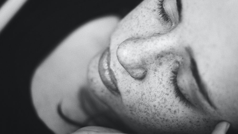 Black & white close-up of girl sleeping